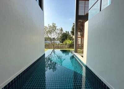 Modern home outdoor pool with clear blue water and scenic views