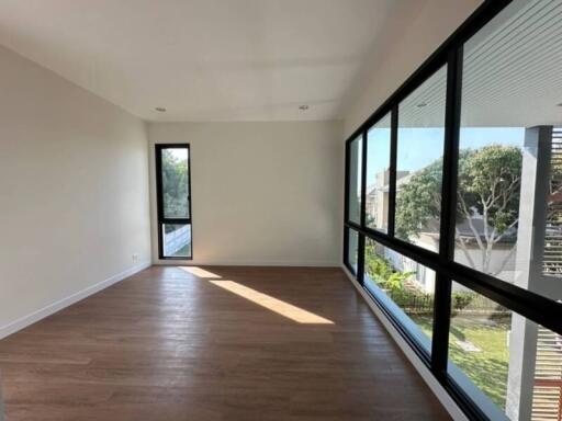 Spacious living room with large windows and hardwood floors