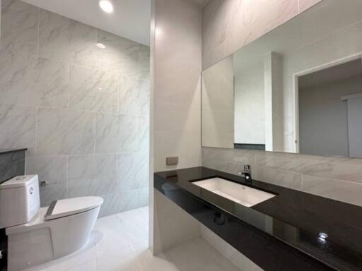 Modern bathroom with marble tiles and sleek fixtures