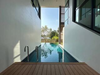 Modern house with outdoor swimming pool and wooden deck