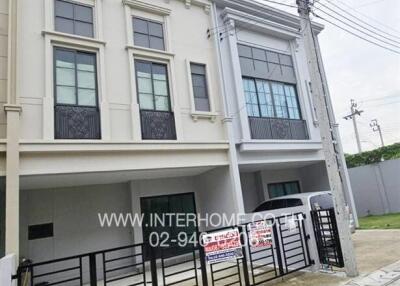 Modern townhouse exterior with secure entry and parking space