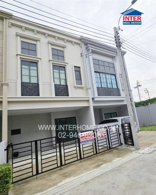 Modern townhouse exterior with secure entry and parking space