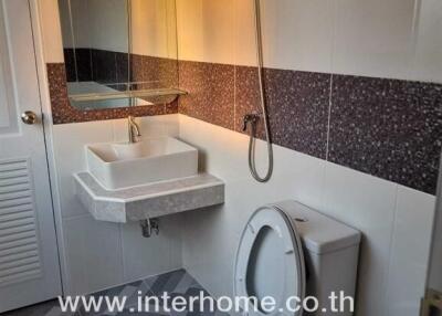 Modern bathroom with wall-mounted sink and toilet