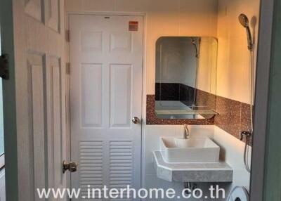 Compact modern bathroom with white fixtures and mosaic tile decoration