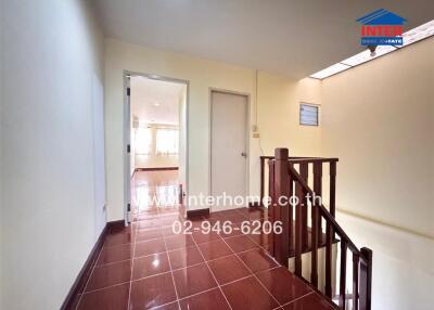 Bright and spacious hallway leading to rooms with tile flooring