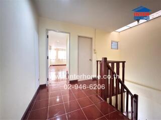 Bright and spacious hallway leading to rooms with tile flooring