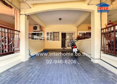 Spacious covered parking area with tiled flooring and neat exterior