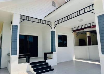Modern home exterior with elegant white porch and dark framed windows