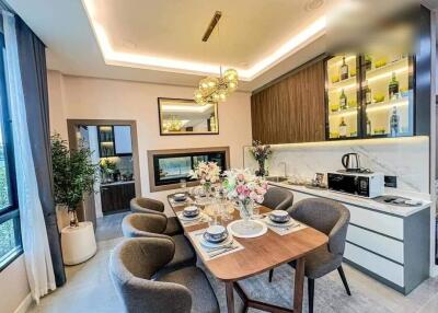 Modern kitchen with integrated dining area featuring stylish decor and lighting