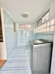 Bright and clean laundry room with modern appliances and ample storage space