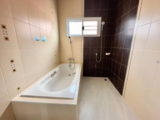 Modern bathroom with bathtub and tiled walls