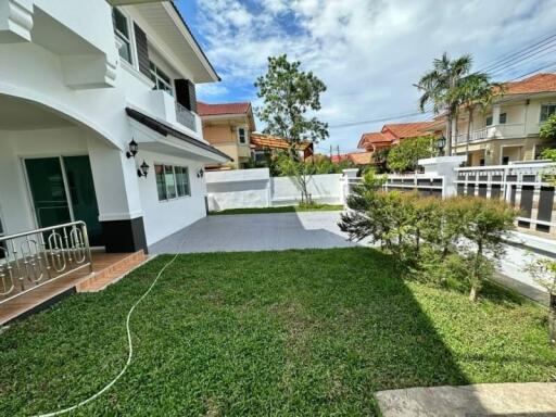 Spacious and well-maintained front yard of a modern residential home with a lush green lawn