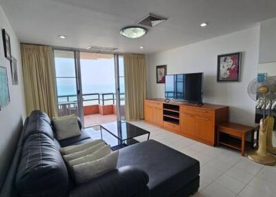Spacious living room with a sea view, comfortable seating, and a balcony