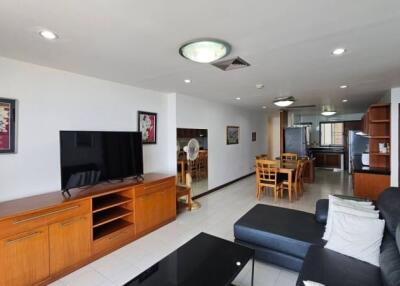 Spacious living room with connected dining area and modern kitchen