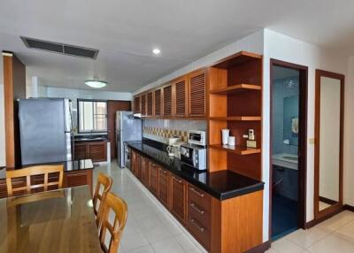 Modern kitchen with wooden cabinets and integrated dining area