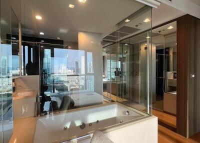 Modern bedroom with integrated bathroom and city view