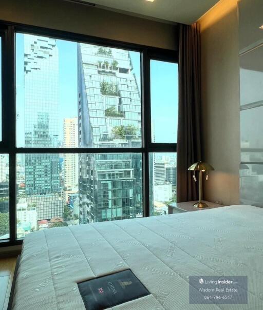 Modern bedroom with expansive city view through large window