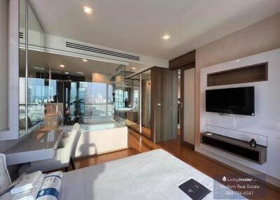 Spacious bedroom with modern design, large windows, city view