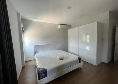 Spacious and modern bedroom with large bed and wardrobes