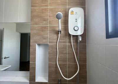Modern bathroom with wall-mounted water heater and shower