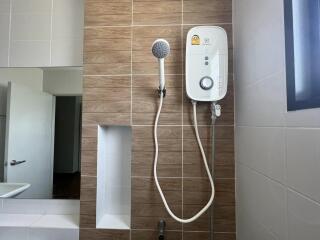 Modern bathroom with wall-mounted water heater and shower