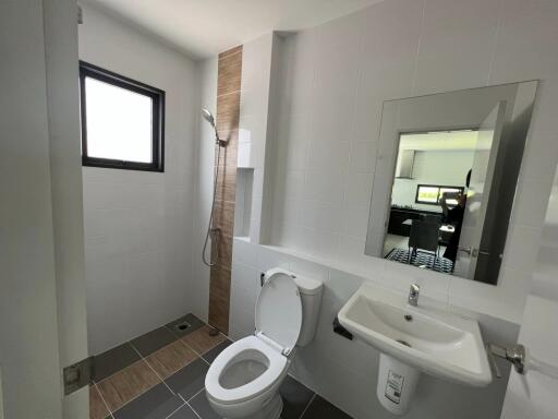 Modern bathroom with a view of the kitchen in the mirror