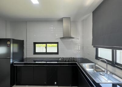 Modern kitchen with black countertops and stainless steel appliances