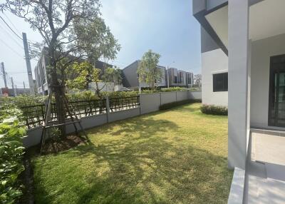 Spacious and well-maintained garden area outside modern homes