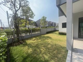 Spacious and well-maintained garden area outside modern homes