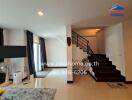 Spacious living room with modern staircase and natural lighting