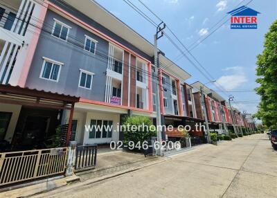 Modern residential townhouses facade with parking spaces