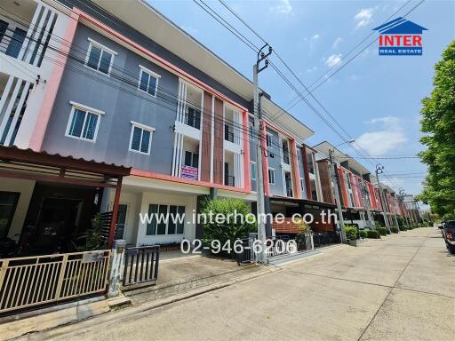 Modern residential townhouses facade with parking spaces