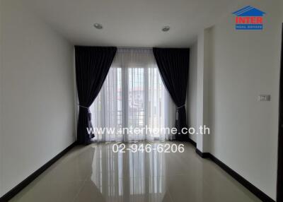 Spacious and bright living room with large windows and curtain