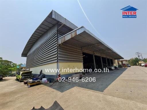 Spacious industrial warehouse with open bays and ample parking