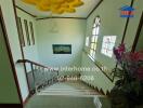 Bright staircase with decorative windows and artistic railing