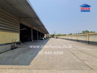 Spacious empty warehouse with open entrance and high ceiling