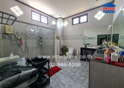 Spacious modern bathroom with glass shower and extensive counter space