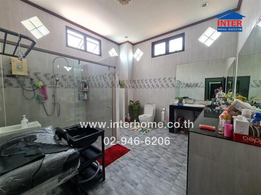 Spacious modern bathroom with glass shower and extensive counter space