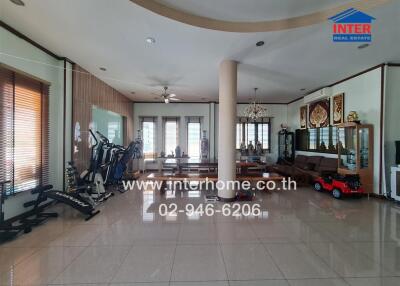 Spacious living room with dining area and home gym equipment
