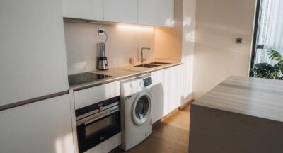 Modern kitchen with built-in appliances and wooden cabinets