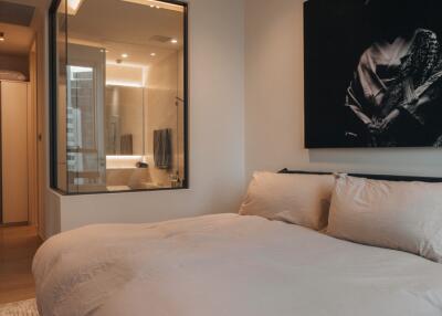 Modern bedroom with ensuite bathroom and artistic decor