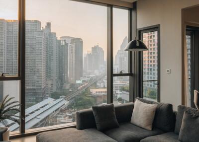 Modern living room with large windows overlooking the city skyline