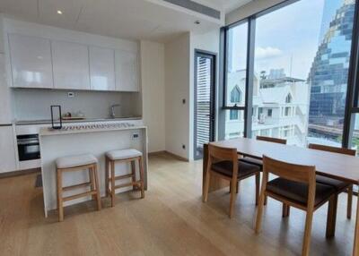 Modern kitchen with dining table overlooking city views through large windows