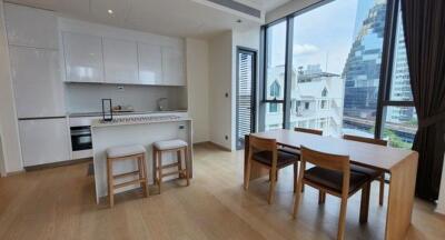 Modern kitchen with dining table overlooking city views through large windows