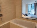 Luxurious bathroom with view into bedroom and cityscape