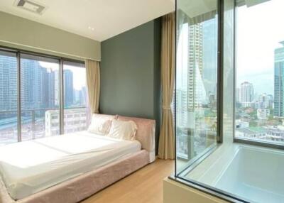 Modern bedroom with large windows showing cityscape