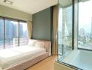 Modern bedroom with city view and floor-to-ceiling windows