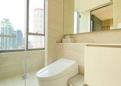 Modern bathroom with large window and city view
