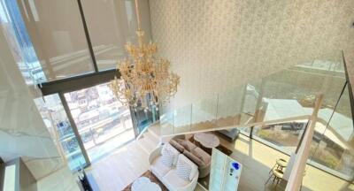 Elegant living room with chandelier and modern staircase