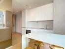 Modern kitchen with white cabinetry and integrated appliances